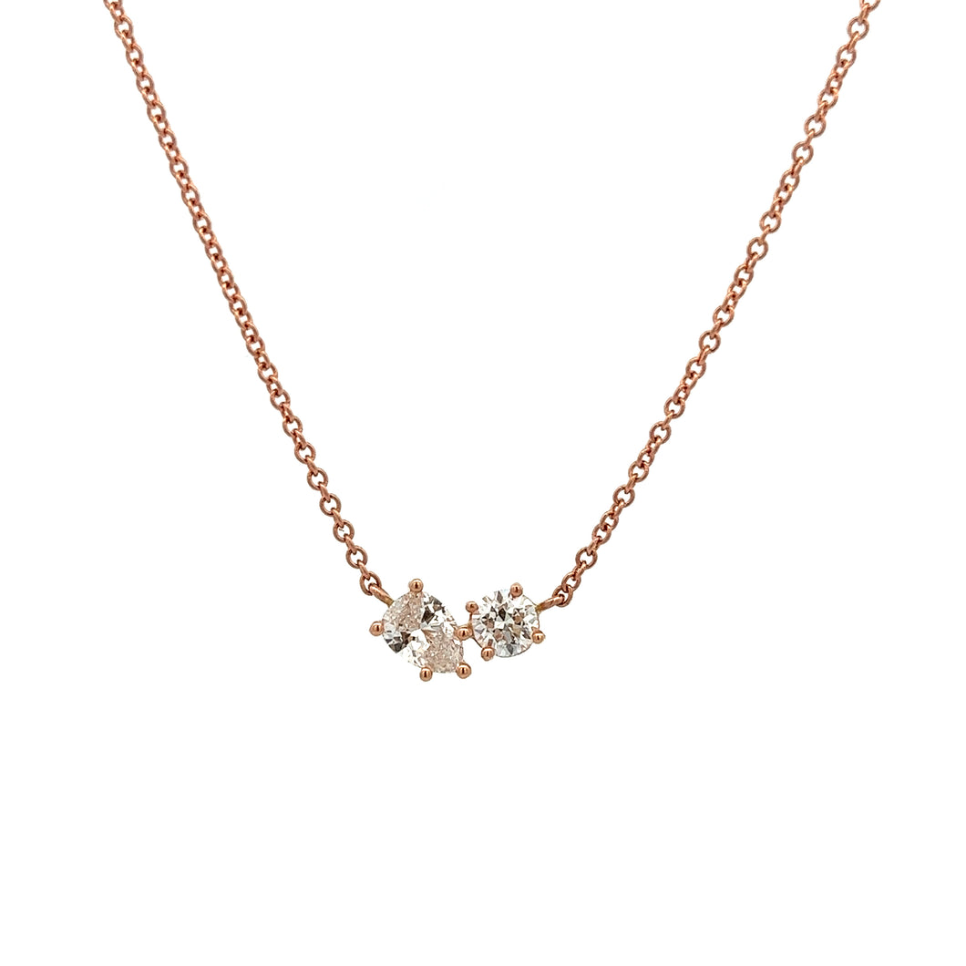 This 14k rose gold necklace features a round brilliant cut diamond ...