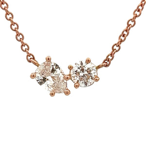 This 14k rose gold necklace features a round brilliant cut diamond ...