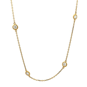This 18k yellow gold by the yard necklace features 18 individual be...