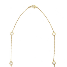 This 18k yellow gold by the yard necklace features 18 individual be...