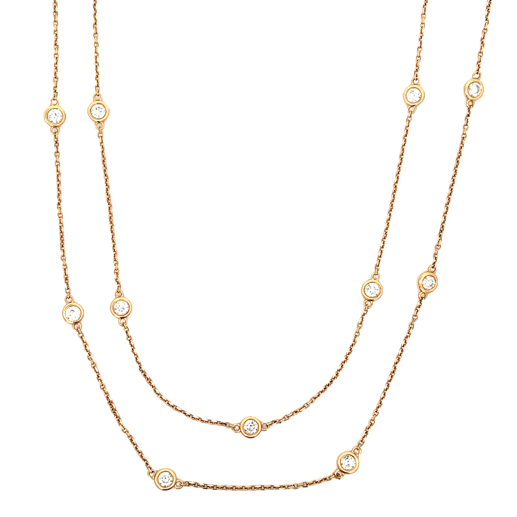 This 18k rose gold by the yard necklace features 18 individual beze...
