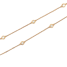 This 18k rose gold by the yard necklace features 18 individual beze...