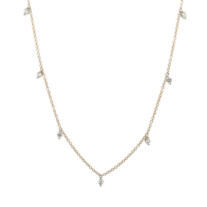 This 14k yellow gold necklace features 7 round brilliant cut diamon...