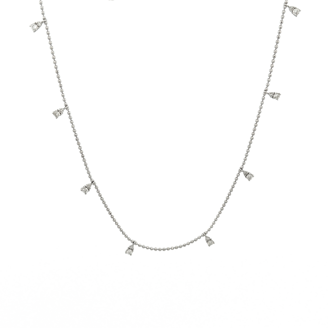 This dainty 14k white gold necklace features diamond drops that tot...
