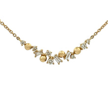 This 14k yellow gold necklace features round brilliant cut diamonds...