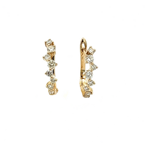 These dainty diamond huggy earrings feature round brilliant cut dia...