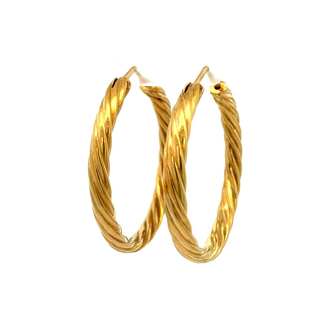 Stylish 18k yellow gold twist hoops. Hoop diameter is 1.5