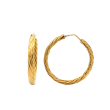 Stylish 18k yellow gold twist hoops. Hoop diameter is 1.5