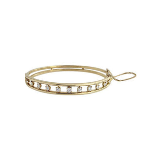 This bangle bracelet features 11 round brilliant cut diamonds that ...