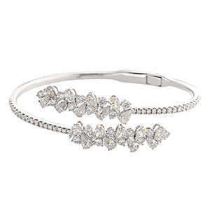 This diamond bracelet features pear and round brilliant cut diamond...