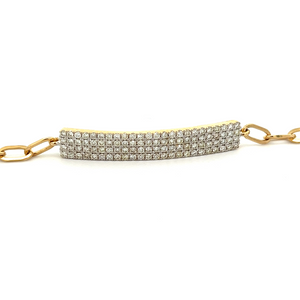 This 14k yellow gold link bracelet features a bar with pave-set dia...