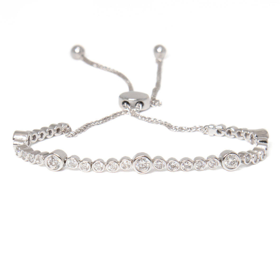 This bolo bracelet features round brilliant cut, bezel set diamonds...