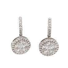 These classic earrings feature round brilliant cut diamonds totalin...