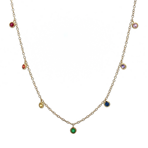 This dainty 14k yellow gold necklace features 7 mixed colored sapph...