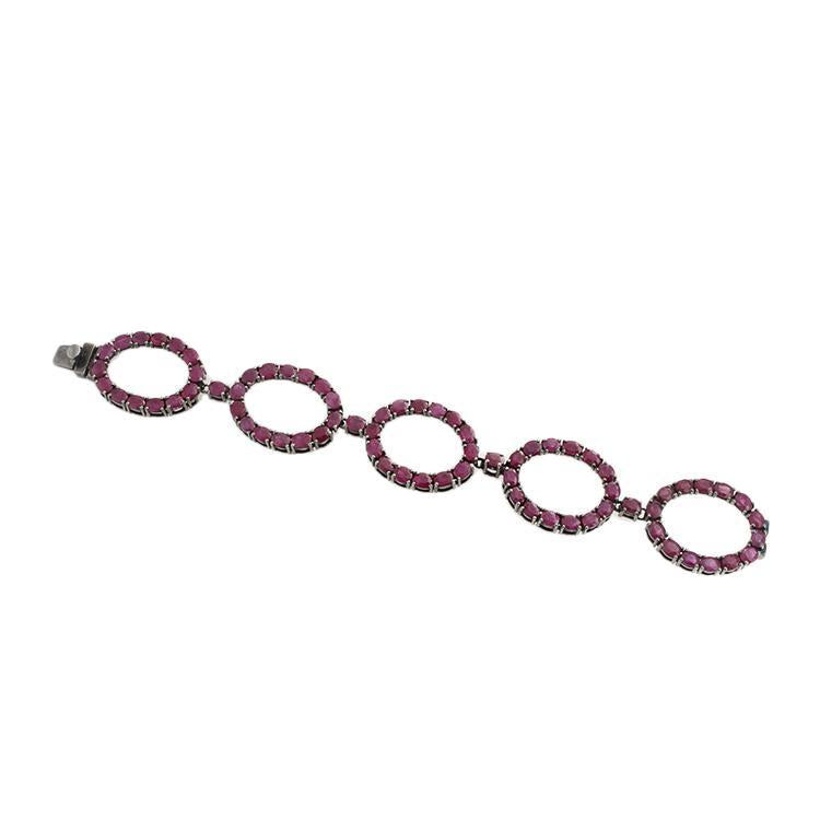 This bracelet features oval rubies that total 34.50cts.