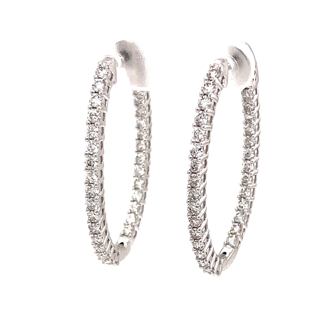 Thes oval shaped hoops feature round brilliant cut diamonds totalin...