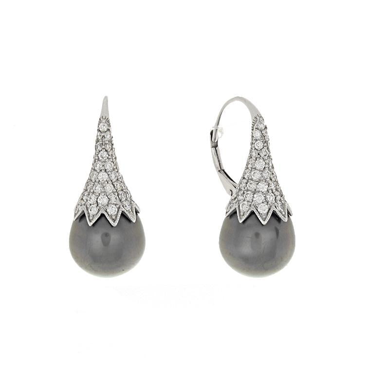 These earrings feature diamonds that total .95cts with an 11mm Tahi...
