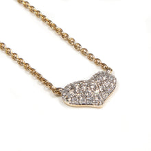 This mini heart pendant features 37 round brilliant cut diamonds to...