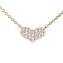 This mini heart pendant features 37 round brilliant cut diamonds to...