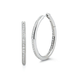 These earrings feature round brilliant cut diamonds that total 1.00...
