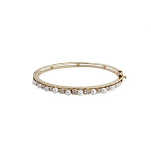 This estate bracelet features pearls and round brilliant cut diamon...