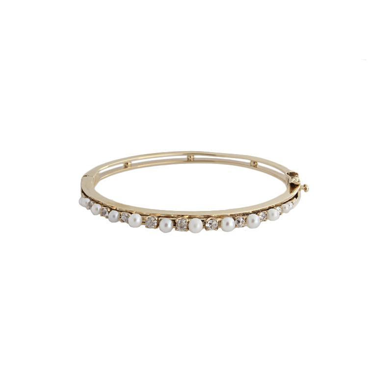 This estate bracelet features pearls and round brilliant cut diamon...