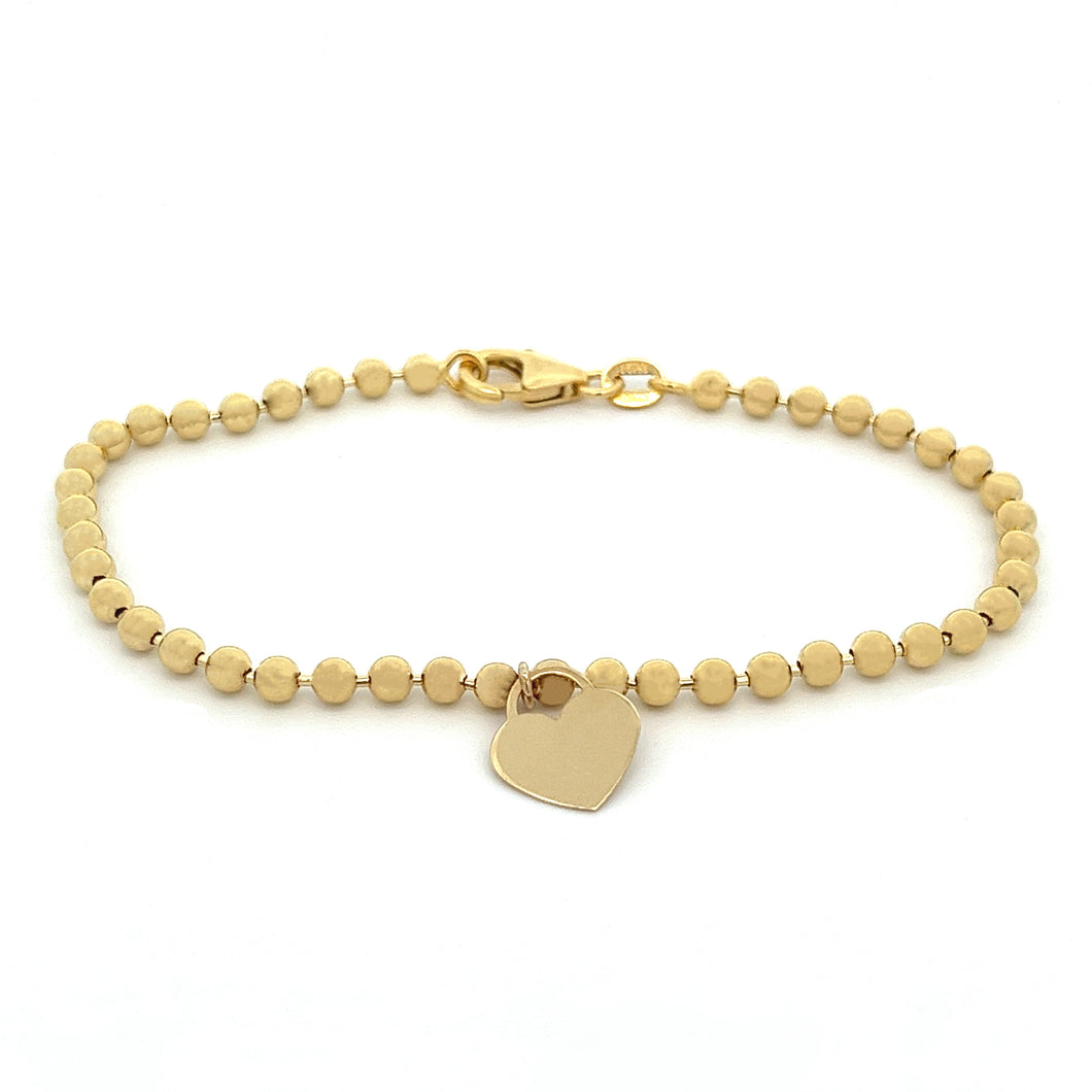 14k yellow gold bead chain bracelet with heart charm.
Bracelet is 7...