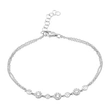 This diamond bracelet features round brilliant cut diamonds that to...