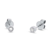 These diamond stud earrings feature two round brilliant cut diamond...