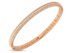 This bangle from Roberto Coin features round brilliant cut diamonds...