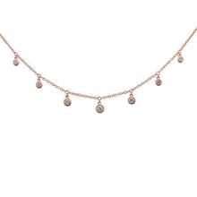 This diamond necklace features bezel set round brilliant cut diamon...