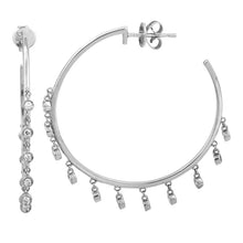 These hoop earrings features round brilliant cut diamonds that tota...