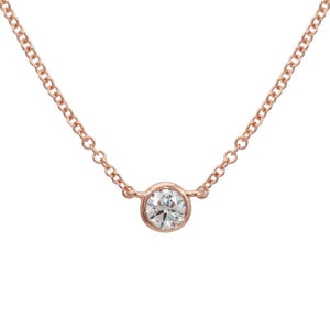 This necklace features a bezel set round brilliant cut diamond that...