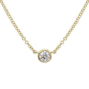 This necklace features a .12ct round brilliant cut diamond set in a...