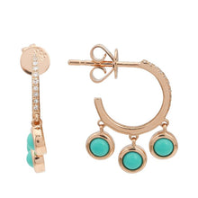 The earrings features turquoise drops.