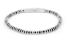 








Irregular shaped, hand-polished silver discs sit stacked t...