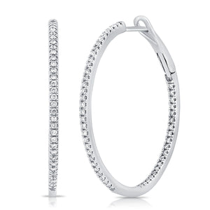 These diamond hoop earrings feature .48cts of round brilliant cut d...