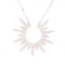 This modern sunburst pendant features round brillinat cut diamonds ...