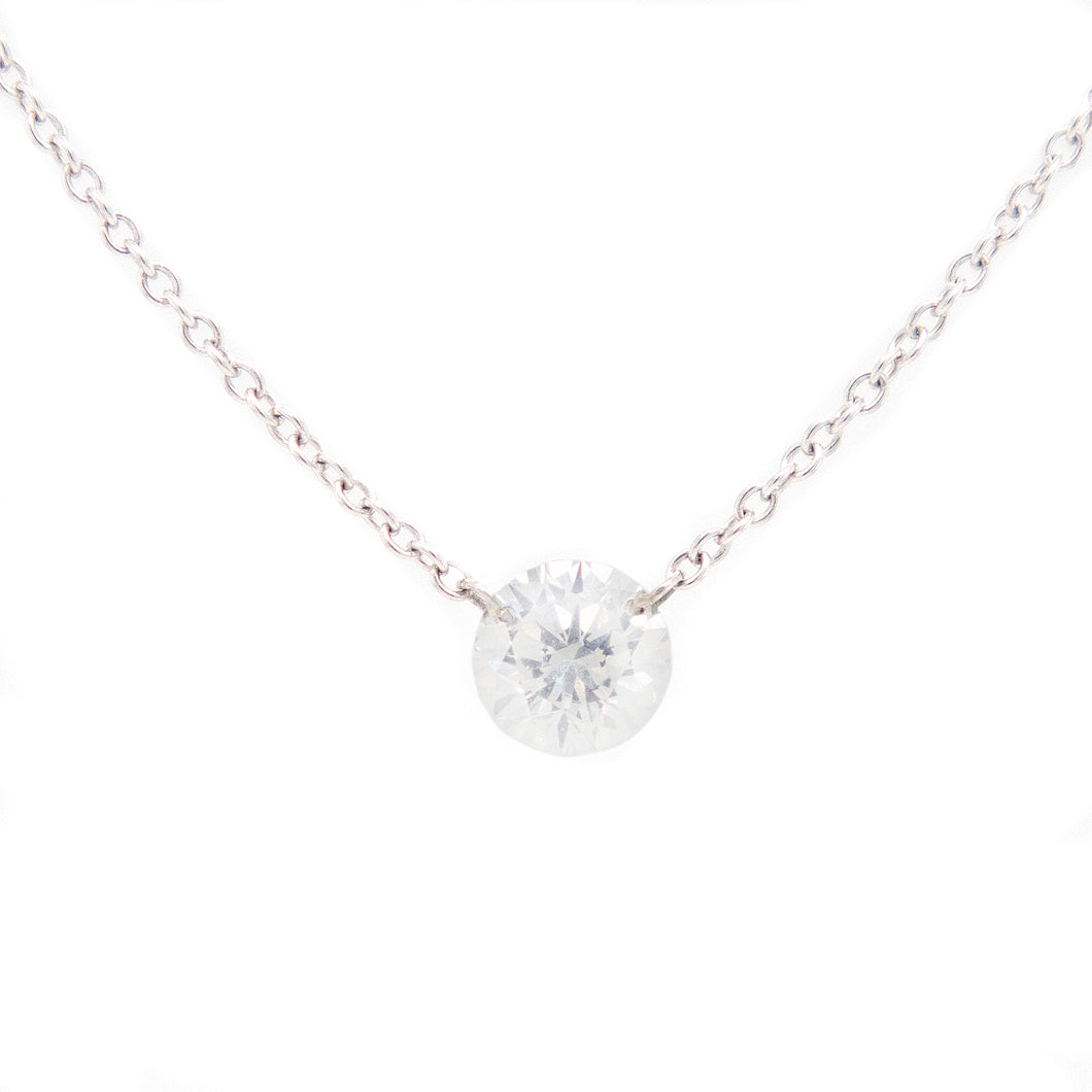 This minimalist pendant features a round brilliant cut diamond tota...