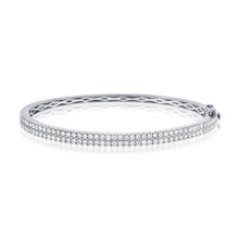 This bangle features pave set round brilliant cut diamonds that tot...
