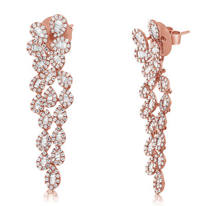 These diamond earrings feature baguette and round brilliant cut dia...