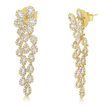 These diamond earrings feature baguette and round brilliant cut dia...