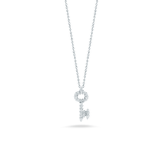 A mini key pendant with diamonds totaling .16ct on an 18