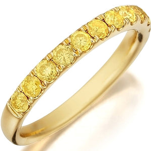 This stylish gold band by Henri Daussi features a single line of na...