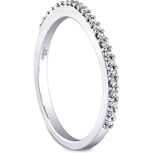 This diamond wedding band by Jeff Cooper features prong set round b...