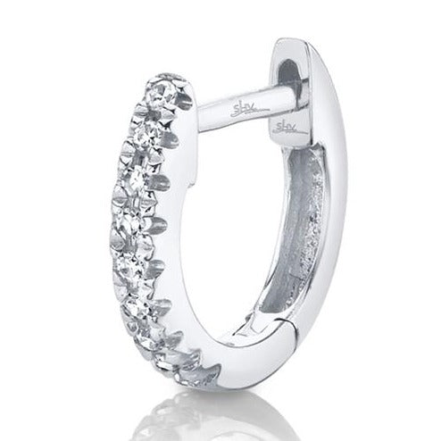 This single diamond huggy earring feature .02cts of round brilliant...