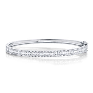 This diamond bangle features round brilliant cut and baguette diamo...