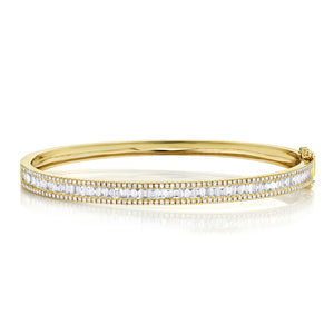 This diamond bangle features round brilliant cut and baguette diamo...