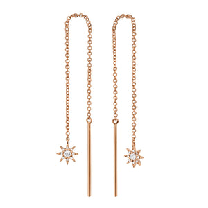 These earrings features star drops with round brilliant cut diamond...