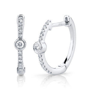 These earrings feature round brilliant cut diamonds that total .23cts.